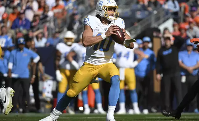 Los Angeles Chargers quarterback Justin Herbert (10) looks to pass during the first half of an NFL football game against the Denver Broncos, Sunday, Oct. 13, 2024, in Denver. (AP Photo/Geneva Heffernan)