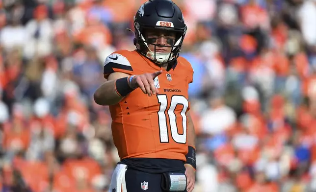 Denver Broncos quarterback Bo Nix (10) points during the second half of an NFL football game against the Los Angeles Chargers, Sunday, Oct. 13, 2024, in Denver. (AP Photo/Geneva Heffernan)