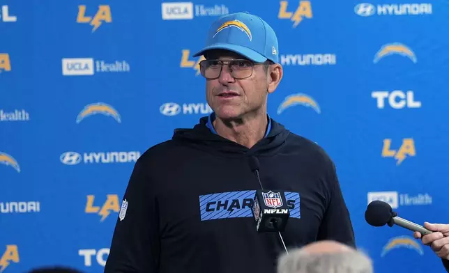 Los Angeles Chargers head coach Jim Harbaugh responds to a question during news conference after defeating the Denver Broncos in an NFL football game Sunday, Oct. 13, 2024, in Denver. (AP Photo/David Zalubowski)