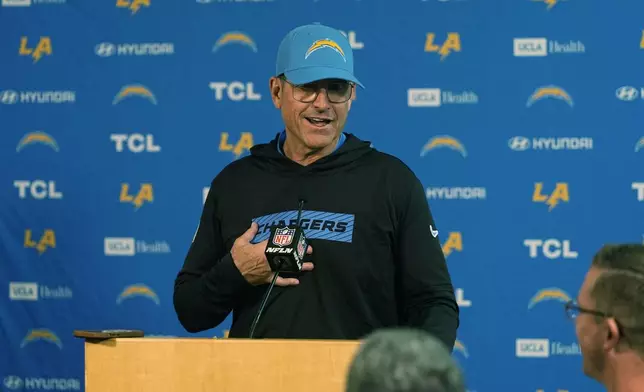 Los Angeles Chargers head coach Jim Harbaugh responds to a question during news conference after defeating the Denver Broncos in an NFL football game Sunday, Oct. 13, 2024, in Denver. (AP Photo/David Zalubowski)