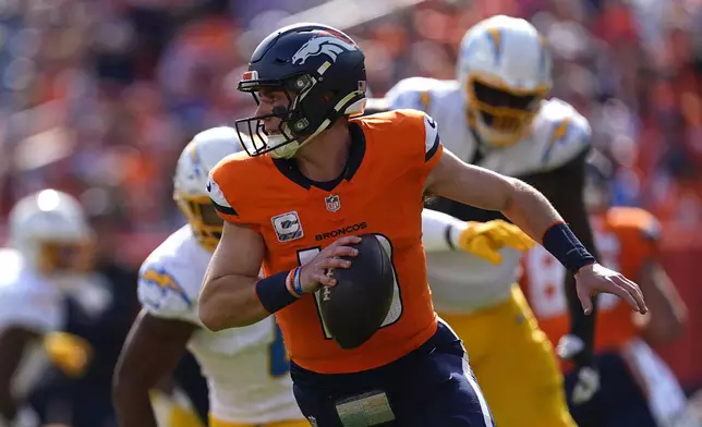 Denver Broncos quarterback Bo Nix (10) scrambles during the first half of an NFL football game against the Los Angeles Chargers, Sunday, Oct. 13, 2024, in Denver. (AP Photo/David Zalubowski)