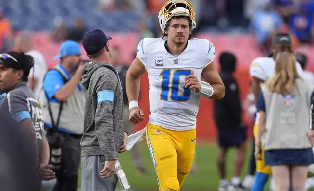 Los Angeles Chargers quarterback Justin Herbert heads off the field after an NFL football game against the Denver Broncos, Sunday, Oct. 13, 2024, in Denver. (AP Photo/David Zalubowski)