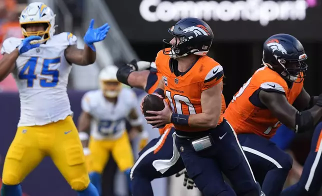 Denver Broncos quarterback Bo Nix, center, is pursued by Los Angeles Chargers linebacker Tuli Tuipulotu (45) in the second half of an NFL football game Sunday, Oct. 13, 2024, in Denver. (AP Photo/David Zalubowski)