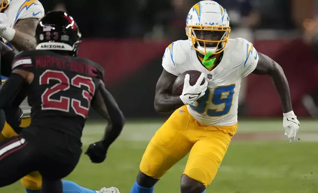 Los Angeles Chargers wide receiver Jalen Reagor (89) runs from Arizona Cardinals cornerback Sean Murphy-Bunting (23) after catching a pass during the first half of an NFL football game, Monday, Oct. 21, 2024, in Glendale Ariz. (AP Photo/Matt York)