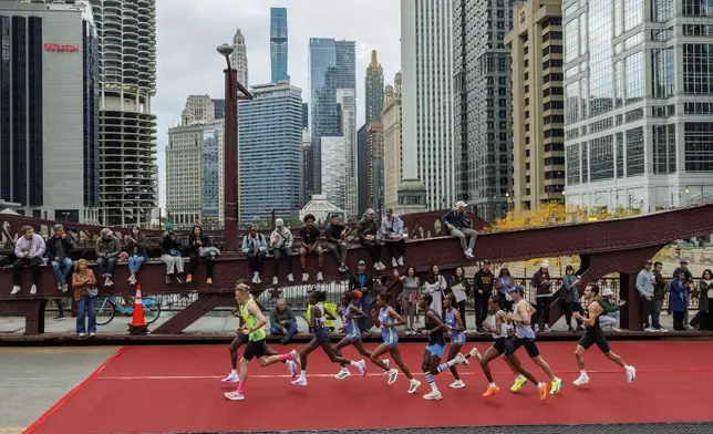 Runners cross the LaSalle Street bridge during the Chicago Marathon Sunday Oct. 13, 2024, in Chicago. (Armando L. Sanchez//Chicago Tribune via AP)