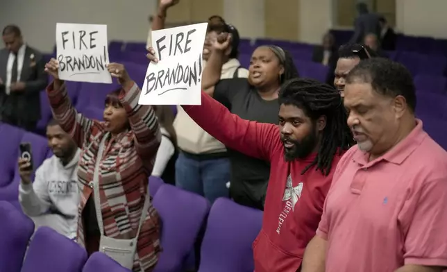 A group of residents disrupt a news conference as Chicago Mayor Brandon Johnson introduced six of his nominees to the Chicago Board of Education on Monday, Oct. 7, 2024, in Chicago. (AP Photo/Charles Rex Arbogast)