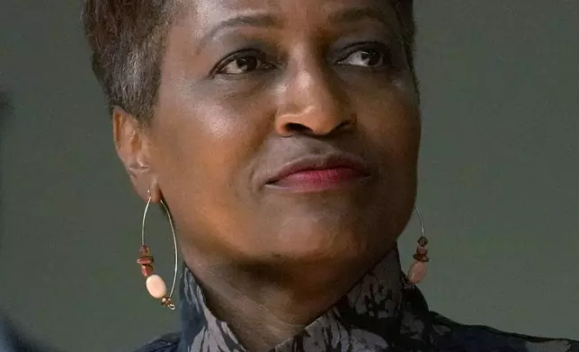 Mary Gardner, one of six nominees by Chicago Mayor Brandon Johnson to the Chicago Board of Education, listens to the mayor during a news conference introducing his nominees Monday, Oct. 7, 2024, in Chicago. (AP Photo/Charles Rex Arbogast)