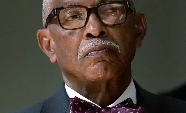 Frank Niles Thomas, one of six nominees by Chicago Mayor Brandon Johnson to the Chicago Board of Education listens to the mayor during a news conference introducing his nominees Monday, Oct. 7, 2024, in Chicago. (AP Photo/Charles Rex Arbogast)