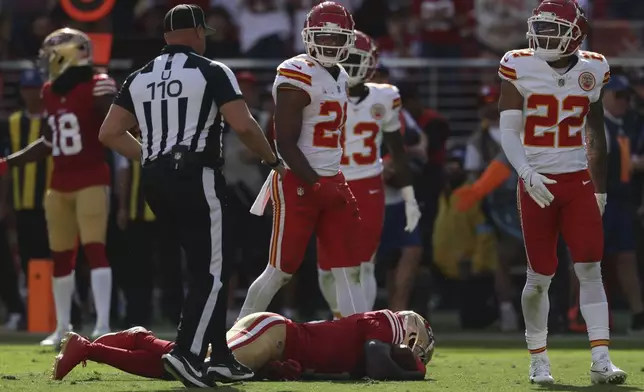 San Francisco 49ers wide receiver Brandon Aiyuk, bottom, remains on the field after being hit during the first half of an NFL football game against the Kansas City Chiefs in Santa Clara, Calif., Sunday, Oct. 20, 2024. (AP Photo/Jed Jacobsohn)