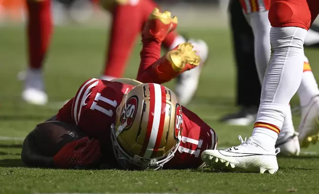 San Francisco 49ers wide receiver Brandon Aiyuk (11) remains on the field after being hit during the first half of an NFL football game against the Kansas City Chiefs in Santa Clara, Calif., Sunday, Oct. 20, 2024. (AP Photo/Eakin Howard)