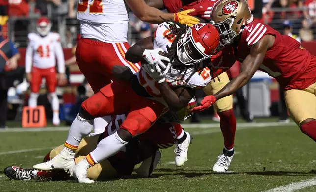 Kansas City Chiefs running back Kareem Hunt, middle, runs for a touchdown against the San Francisco 49ers during the first half of an NFL football game in Santa Clara, Calif., Sunday, Oct. 20, 2024. (AP Photo/Eakin Howard)