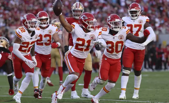 Kansas City Chiefs safety Jaden Hicks (21) celebrates with teammates after intercepting a pass during the second half of an NFL football game against the San Francisco 49ers in Santa Clara, Calif., Sunday, Oct. 20, 2024. (AP Photo/Jed Jacobsohn)