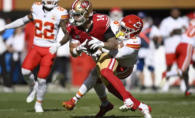 San Francisco 49ers wide receiver Ricky Pearsall (14) catches a pass against Kansas City Chiefs safety Bryan Cook (6) during the first half of an NFL football game in Santa Clara, Calif., Sunday, Oct. 20, 2024. (AP Photo/Eakin Howard)