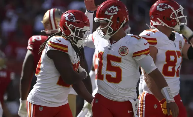 Kansas City Chiefs running back Kareem Hunt, left, is congratulated by quarterback Patrick Mahomes (15) after scoring against the San Francisco 49ers during the first half of an NFL football game in Santa Clara, Calif., Sunday, Oct. 20, 2024. (AP Photo/Jed Jacobsohn)