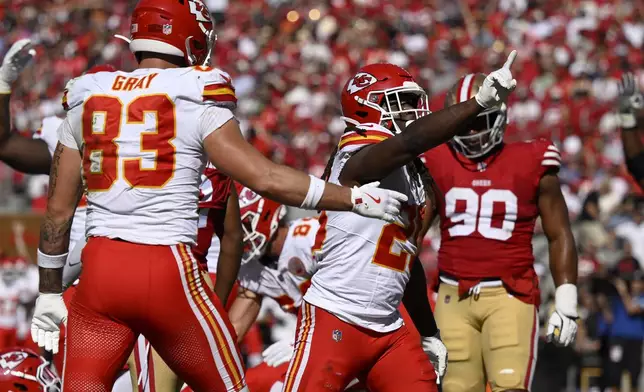 Kansas City Chiefs running back Kareem Hunt, middle, celebrates after scoring against the San Francisco 49ers during the first half of an NFL football game in Santa Clara, Calif., Sunday, Oct. 20, 2024. (AP Photo/Eakin Howard)