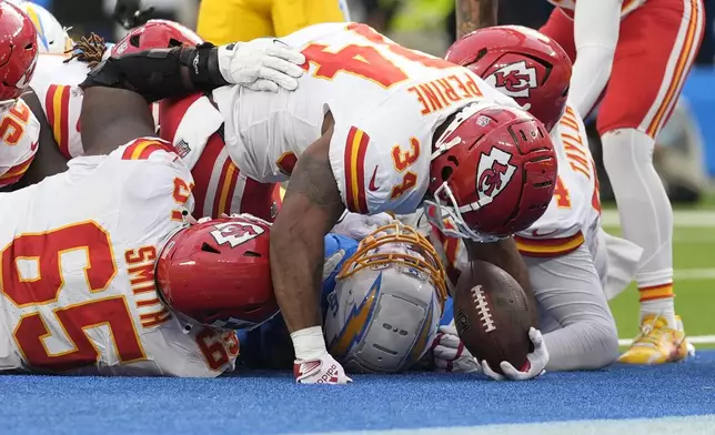 Kansas City Chiefs running back Samaje Perine (34) scores on a 2-yard run during the second half of an NFL football game against the Los Angeles Chargers Sunday, Sept. 29, 2024, in Inglewood, Calif. (AP Photo/Ashley Landis)