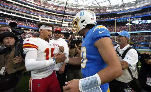 Kansas City Chiefs quarterback Patrick Mahomes (15) and Los Angeles Chargers quarterback Justin Herbert shake hands following an NFL football game Sunday, Sept. 29, 2024, in Inglewood, Calif. The Chiefs won 17-10. (AP Photo/Marcio Jose Sanchez)