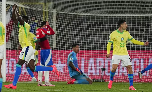 Brazil's Luiz Henrique, left, celebrates after scoring his side's second goal against Chile during a FIFA World Cup 2026 qualifying soccer match at the National Stadium in Santiago, Chile, Thursday, Oct. 10, 2024. (AP Photo/Esteban Felix)