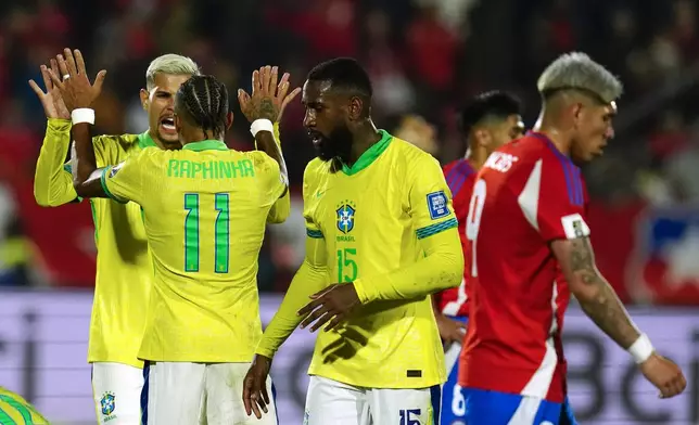 Brazilian players celebrate their 2-1 victory over Chile in a FIFA World Cup 2026 qualifying soccer match at the National Stadium in Santiago, Chile, Thursday, Oct. 10, 2024. (AP Photo/Esteban Felix)