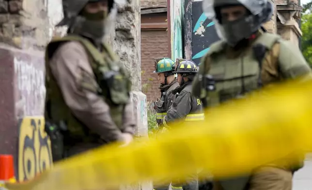 Firefighters respond to a fire at the Barros Arana National Boarding School (INBA) in Santiago Chile, Wednesday, Oct. 23, 2024. (AP Photo/Esteban Felix)