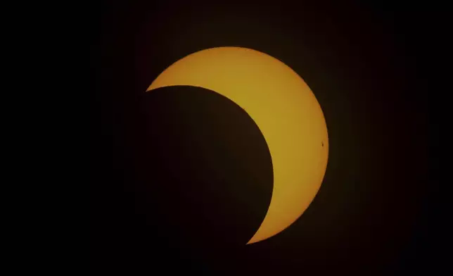 The moon moves across the sun during an annular solar eclipse in Tahai, Rapa Nui, or Easter Island, Chile, Wednesday, Oct. 2, 2024. (AP Photo/Esteban Felix)