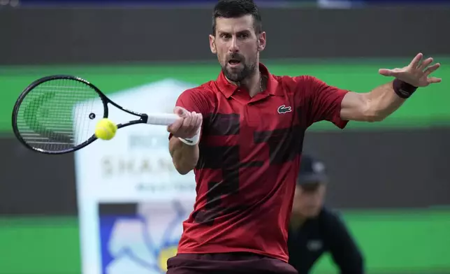 Novak Djokovic of Serbia returns a shot against Jannik Sinner of Italy during the men's singles finals match in the Shanghai Masters tennis tournament at Qizhong Forest Sports City Tennis Center in Shanghai, China, Sunday, Oct. 13, 2024. (AP Photo/Andy Wong)