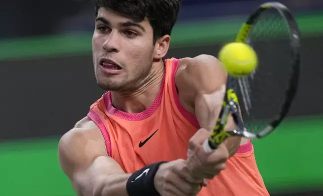 Carlos Alcaraz of Spain plays a backhand return against Tomas Machac of the Czech Republic during the men's singles quarterfinals match in the Shanghai Masters tennis tournament at Qizhong Forest Sports City Tennis Center in Shanghai, China, Thursday, Oct. 10, 2024. (AP Photo/Andy Wong)