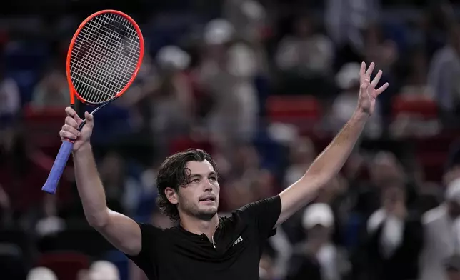 Taylor Fritz of the United States waves to spectators after defeating Terence Atmane of France in the men's singles second round match in the Shanghai Masters tennis tournament at Qizhong Forest Sports City Tennis Center in Shanghai, China, Monday, Oct. 7, 2024. (AP Photo/Andy Wong)