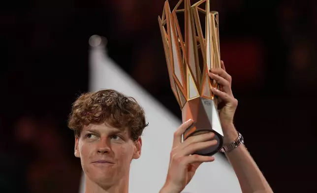 Jannik Sinner of Italy celebrates with his trophy after defeating Novak Djokovic of Serbia in the men's singles finals match for the Shanghai Masters tennis tournament at Qizhong Forest Sports City Tennis Center in Shanghai, China, Sunday, Oct. 13, 2024. (AP Photo/Andy Wong)