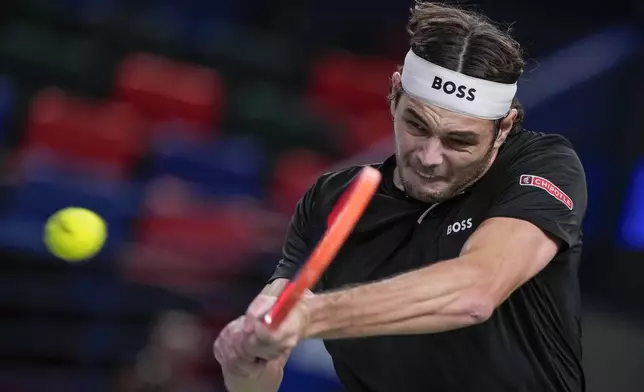 Taylor Fritz of the United States returns a shot to Terence Atmane of France during the men's singles second round match in the Shanghai Masters tennis tournament at Qizhong Forest Sports City Tennis Center in Shanghai, China, Monday, Oct. 7, 2024. (AP Photo/Andy Wong)