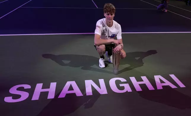 Jannik Sinner of Italy celebrates with his trophy after defeating Novak Djokovic of Serbia in the men's singles finals match for the Shanghai Masters tennis tournament at Qizhong Forest Sports City Tennis Center in Shanghai, China, Sunday, Oct. 13, 2024. (AP Photo/Andy Wong)