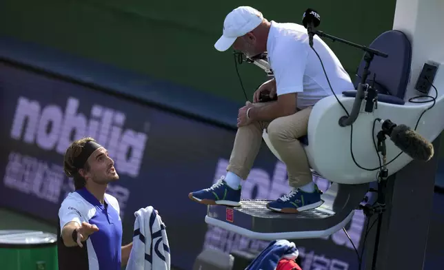 Stefanos Tsitsipas of Greece talks to an umpire during the men's singles fourth round match against Daniil Medvedev of Russia, in the Shanghai Masters tennis tournament at Qizhong Forest Sports City Tennis Center in Shanghai, China, Wednesday, Oct. 9, 2024. (AP Photo/Andy Wong)