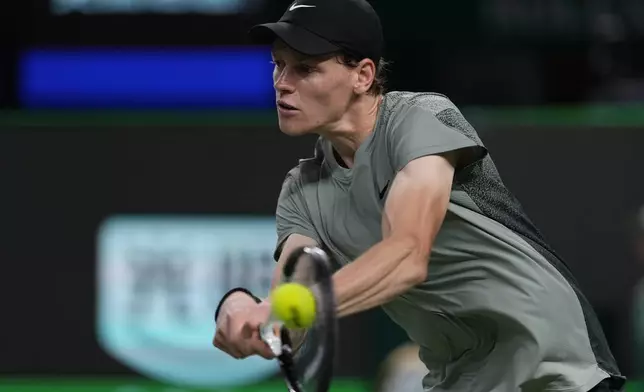 Jannik Sinner of Italy returns a shot against Novak Djokovic of Serbia during the men's singles finals match in the Shanghai Masters tennis tournament at Qizhong Forest Sports City Tennis Center in Shanghai, China, Sunday, Oct. 13, 2024. (AP Photo/Andy Wong)