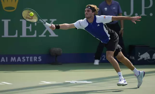 Stefanos Tsitsipas of Greece plays a forehand return against Daniil Medvedev of Russia during the men's singles fourth round match in the Shanghai Masters tennis tournament at Qizhong Forest Sports City Tennis Center in Shanghai, China, Wednesday, Oct. 9, 2024. (AP Photo/Andy Wong)