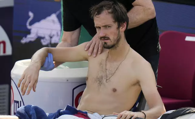 Daniil Medvedev of Russia receives a medical timeout during the men's singles fourth round match against Stefanos Tsitsipas of Greece, in the Shanghai Masters tennis tournament at Qizhong Forest Sports City Tennis Center in Shanghai, China, Wednesday, Oct. 9, 2024. (AP Photo/Andy Wong)