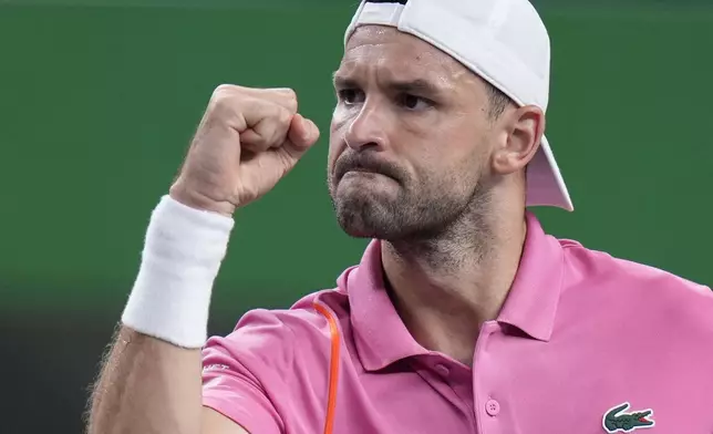 Grigor Dimitrov of Bulgaria reacts during the men's singles second round match against Zizou Bergs of Belgium in the Shanghai Masters tennis tournament at Qizhong Forest Sports City Tennis Center in Shanghai, China, Monday, Oct. 7, 2024. (AP Photo/Andy Wong)