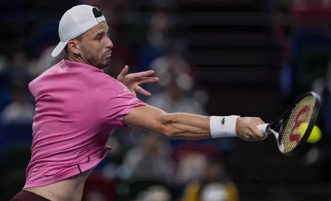 Grigor Dimitrov of Bulgaria returns a shot to Zizou Bergs of Belgium during the men's singles second round match in the Shanghai Masters tennis tournament at Qizhong Forest Sports City Tennis Center in Shanghai, China, Monday, Oct. 7, 2024. (AP Photo/Andy Wong)