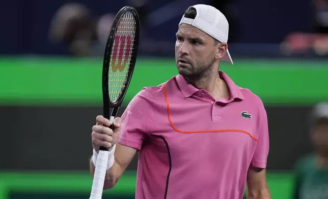 Grigor Dimitrov of Bulgaria reacts during the men's singles second round match against Zizou Bergs of Belgium in the Shanghai Masters tennis tournament at Qizhong Forest Sports City Tennis Center in Shanghai, China, Monday, Oct. 7, 2024. (AP Photo/Andy Wong)