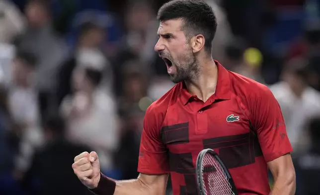 Novak Djokovic of Serbia reacts after defeating Taylor Fritz of the United States in the men's singles semifinals match of the Shanghai Masters tennis tournament at Qizhong Forest Sports City Tennis Center in Shanghai, China, Saturday, Oct. 12, 2024. (AP Photo/Andy Wong)