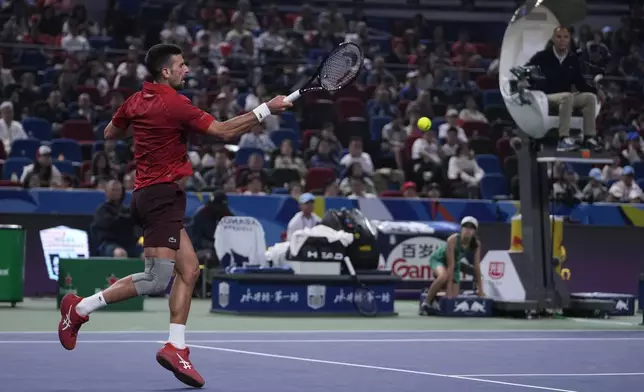 Novak Djokovic of Serbia plays a forehand return against Jake Mensik of the Czech Republic during the men's singles quarterfinals match in the Shanghai Masters tennis tournament at Qizhong Forest Sports City Tennis Center in Shanghai, China, Friday, Oct. 11, 2024. (AP Photo/Andy Wong)