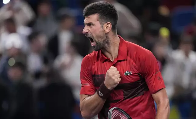 Novak Djokovic of Serbia reacts after defeating Taylor Fritz of the United States in the men's singles semifinals match of the Shanghai Masters tennis tournament at Qizhong Forest Sports City Tennis Center in Shanghai, China, Saturday, Oct. 12, 2024. (AP Photo/Andy Wong)