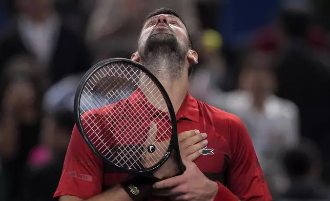 Novak Djokovic of Serbia reacts after defeating Taylor Fritz of the United States in the men's singles semifinals match of the Shanghai Masters tennis tournament at Qizhong Forest Sports City Tennis Center in Shanghai, China, Saturday, Oct. 12, 2024. (AP Photo/Andy Wong)