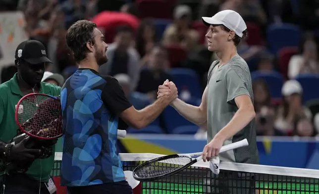 Jannik Sinner of Italy, right, shakes hands with Tomas Machac of the Czech Republic after winning in their men's singles semifinals match of the Shanghai Masters tennis tournament at Qizhong Forest Sports City Tennis Center in Shanghai, China, Saturday, Oct. 12, 2024. (AP Photo/Andy Wong)