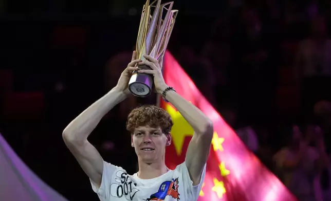 Jannik Sinner of Italy celebrates with his trophy after defeating Novak Djokovic of Serbia in the men's singles finals match for the Shanghai Masters tennis tournament at Qizhong Forest Sports City Tennis Center in Shanghai, China, Sunday, Oct. 13, 2024. (AP Photo/Andy Wong)