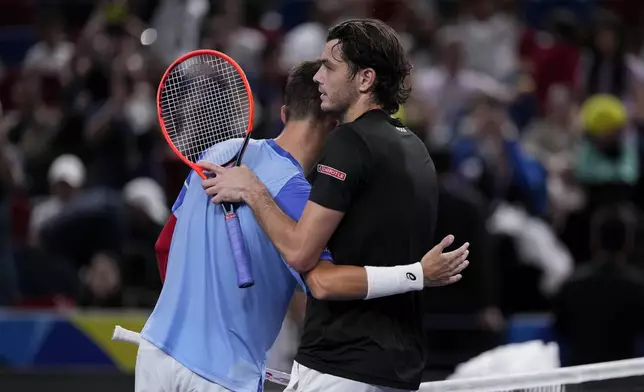 Taylor Fritz of the United States, right, is congratulated by Terence Atmane of France after winning in the men's singles second round match in the Shanghai Masters tennis tournament at Qizhong Forest Sports City Tennis Center in Shanghai, China, Monday, Oct. 7, 2024. (AP Photo/Andy Wong)