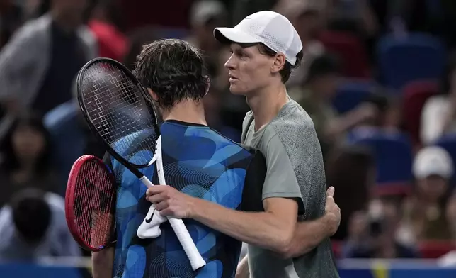 Jannik Sinner of Italy, right, hugs with Tomas Machac of the Czech Republic after winning in their men's singles semifinals match of the Shanghai Masters tennis tournament at Qizhong Forest Sports City Tennis Center in Shanghai, China, Saturday, Oct. 12, 2024. (AP Photo/Andy Wong)