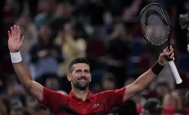 Novak Djokovic of Serbia waves to spectators after defeating Flavio Cobolli of Italy in the men's singles third round match of the Shanghai Masters tennis tournament at Qizhong Forest Sports City Tennis Center in Shanghai, China, Tuesday, Oct. 8, 2024. (AP Photo/Andy Wong)