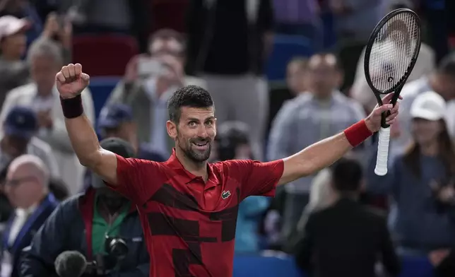 Novak Djokovic of Serbia celebrates after defeating Taylor Fritz of the United States in the men's singles semifinals match of the Shanghai Masters tennis tournament at Qizhong Forest Sports City Tennis Center in Shanghai, China, Saturday, Oct. 12, 2024. (AP Photo/Andy Wong)