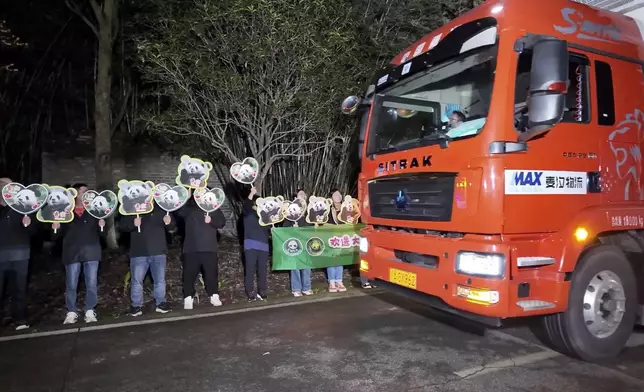 In this image taken from video and released by China's National Forestry and Grassland Administration, workers send off the pair of giant pandas Bao Li and Qing Bao from the Dujiangyan Base of the China Conservation and Research Center for the Giant Panda in southwestern China's Sichuan province on Monday, Oct. 14, 2024. (Jin Tao/China's National Forestry and Grassland Administration via AP)