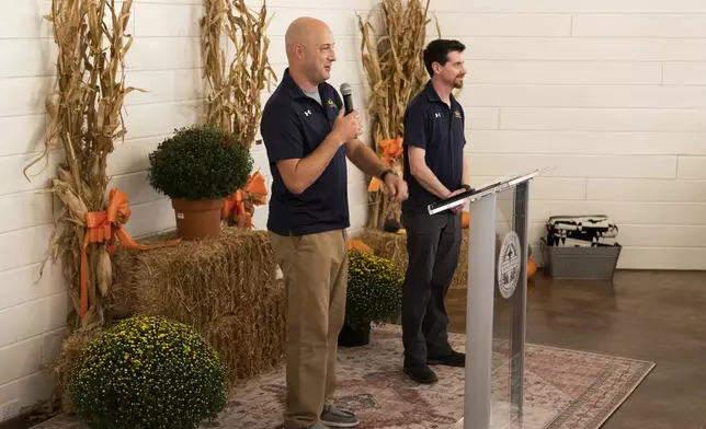 Andrew Frederiksen, left, and Pete Murray from Firaxis Games speak at the ribbon cutting ceremony of the Shawnee Language Center on Friday, September 20, 2024 in Miami, Okla.. (AP Photo/Nick Oxford)